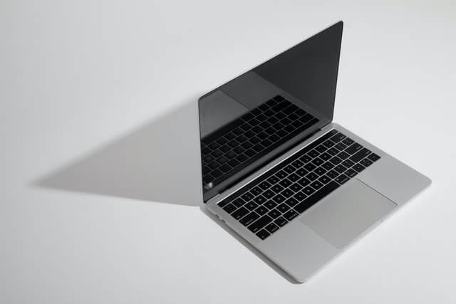 laptop open on a gray background